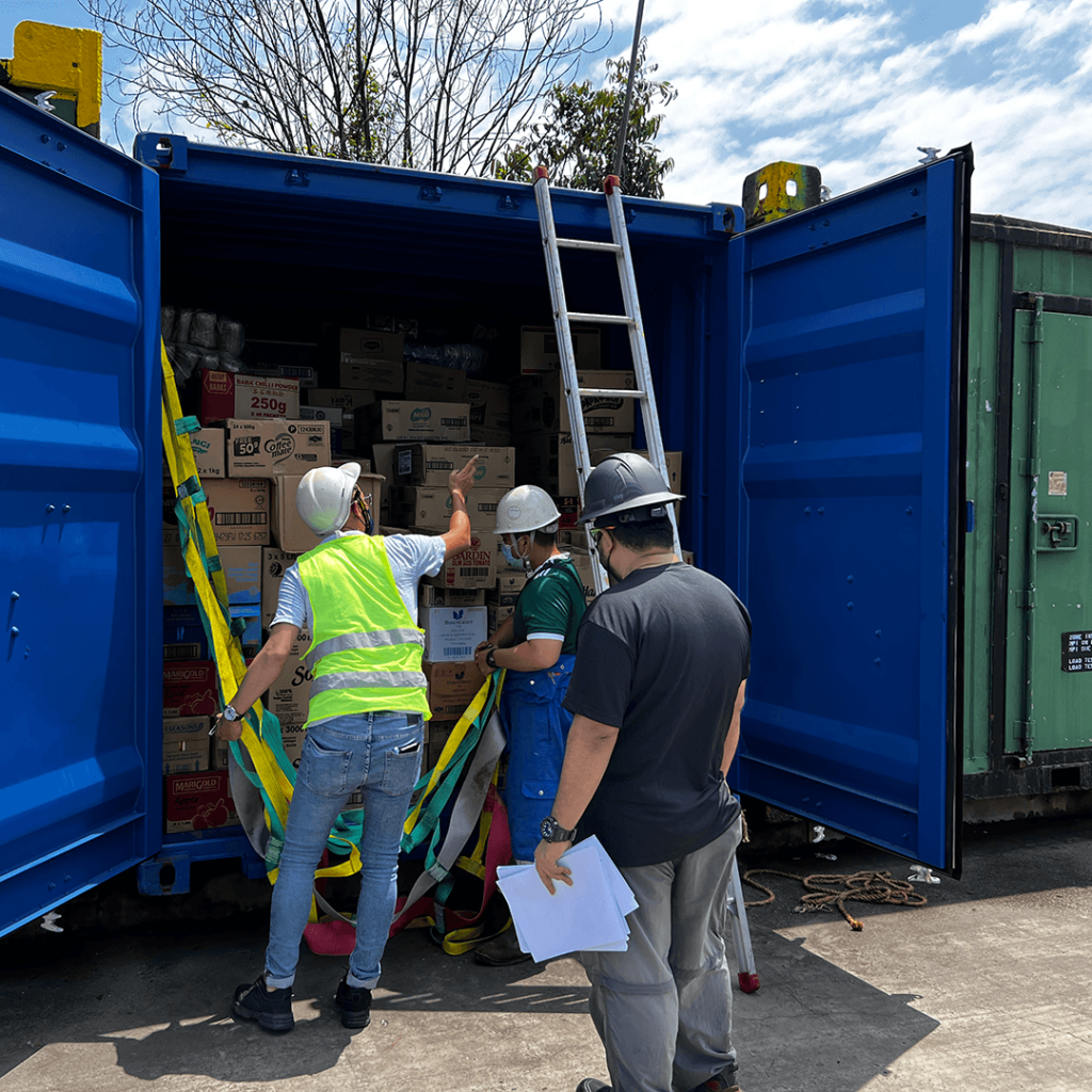 Crew loading provisions into a container